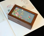 Wooden jewelry box with floral design on a white surface