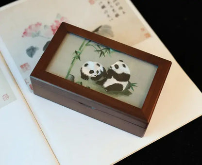 Wooden box with panda design on a floral background