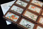 Set of wooden picture frames with embroidered panda and floral designs.