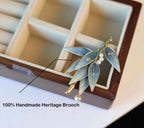 Handmade heritage brooch with leaves and pearls in a wooden box