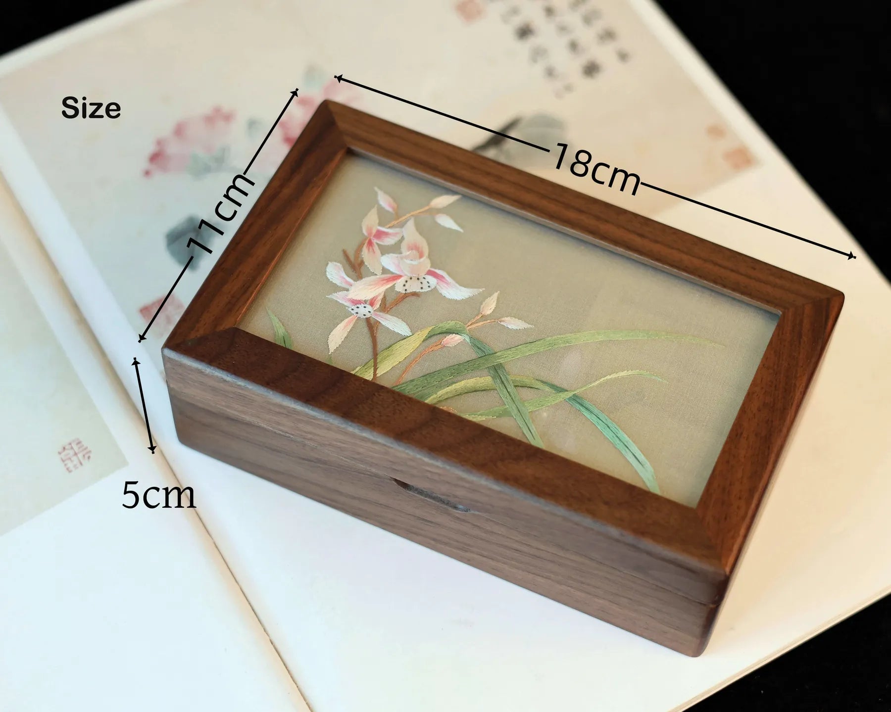 Wooden box with floral design and measurements on a floral background