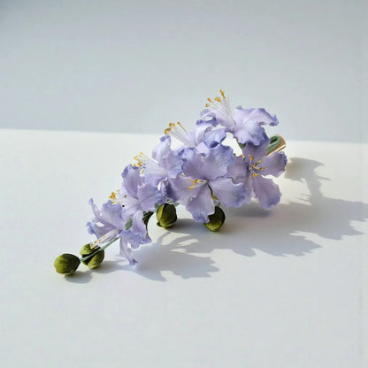 Floral hair accessory on a white surface with a light gray background