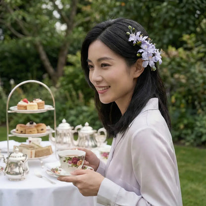 Woman enjoying afternoon tea outdoors with a floral headpiece.