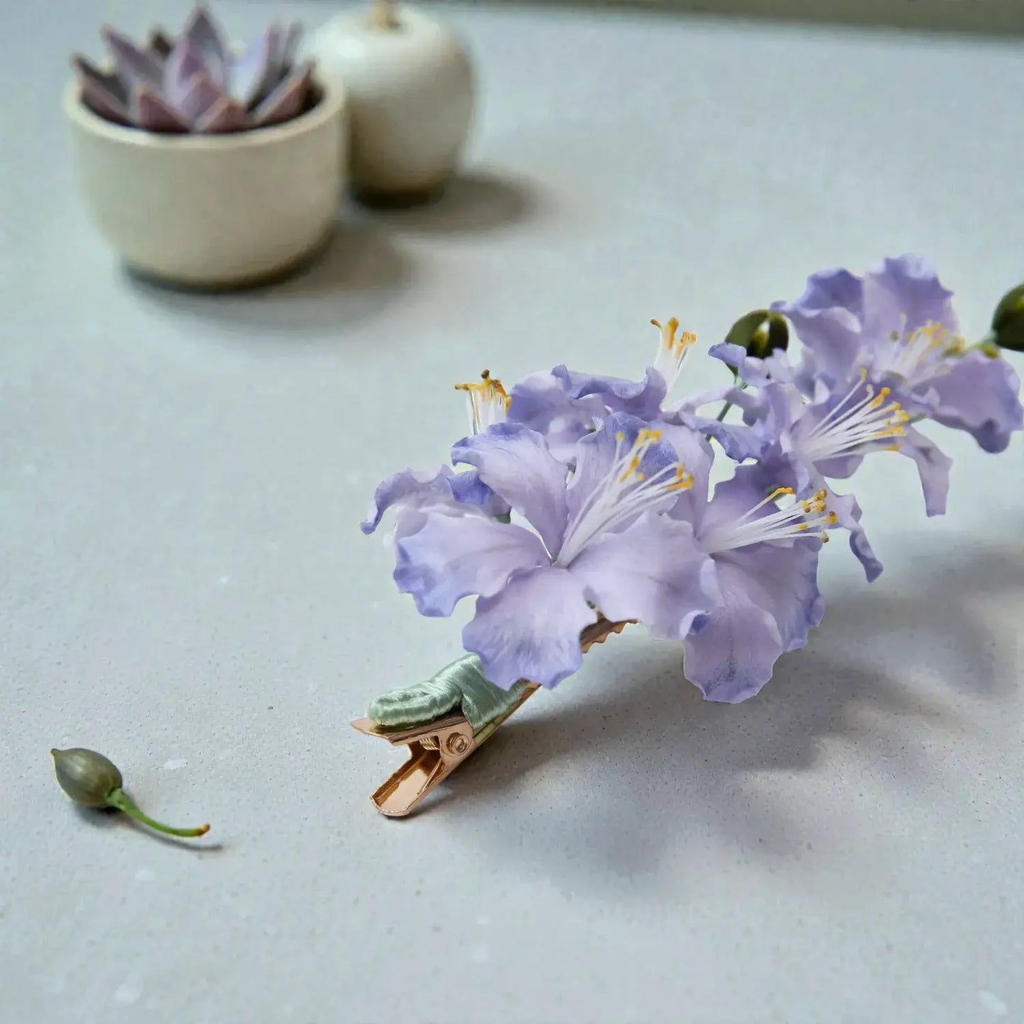Purple flower on a clothespin with a light gray background