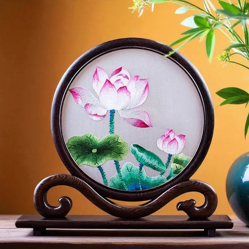 Decorative piece with lotus flower design on a stand against a warm background