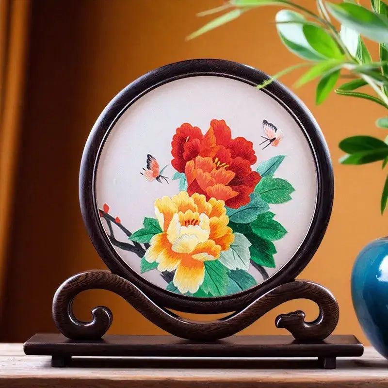 Decorative plate with floral design on a wooden stand against a warm background