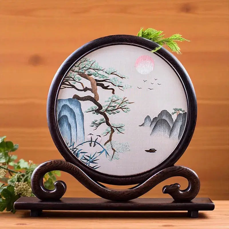 Decorative plate with nature design on a wooden stand against a wooden background