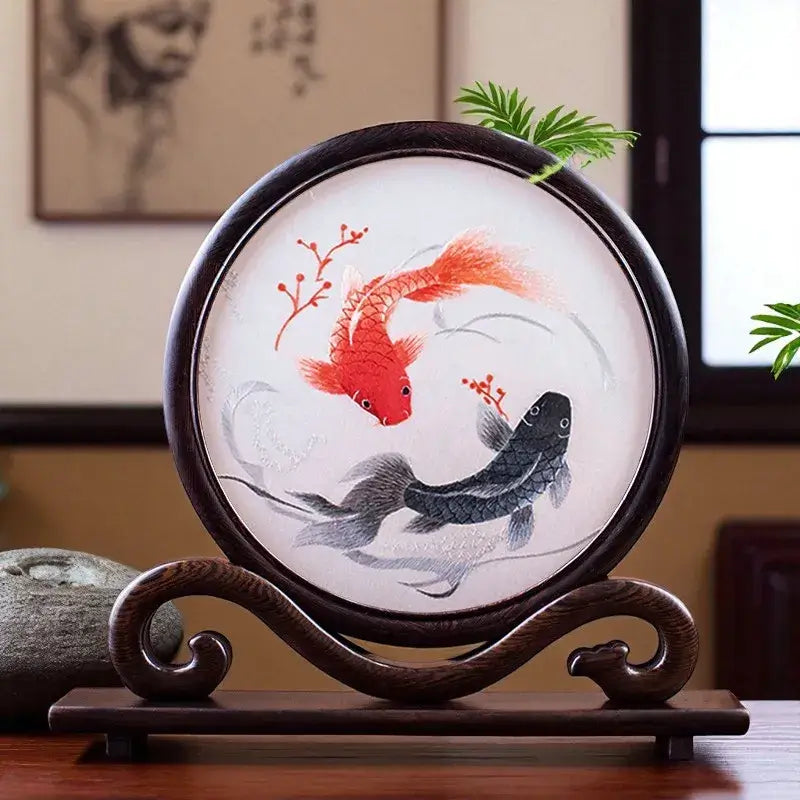 Decorative plate with goldfish design on a wooden stand
