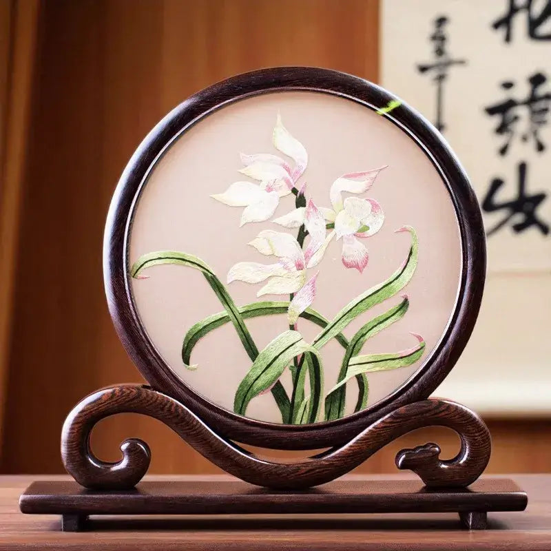 Decorative piece with embroidered flowers on a wooden stand