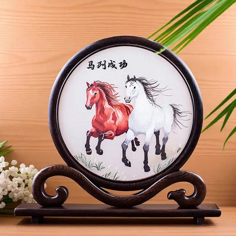 Decorative plate with two horses on a wooden stand against a wooden background