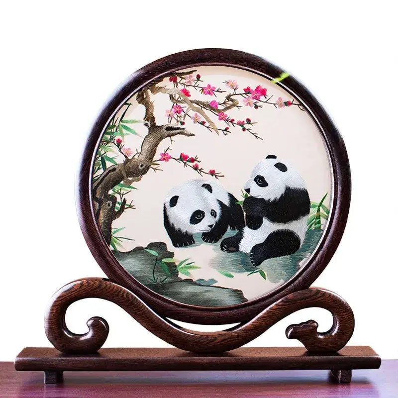 Decorative plate with panda design on a wooden stand