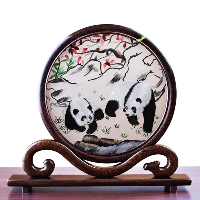Decorative plate with panda design on a wooden stand