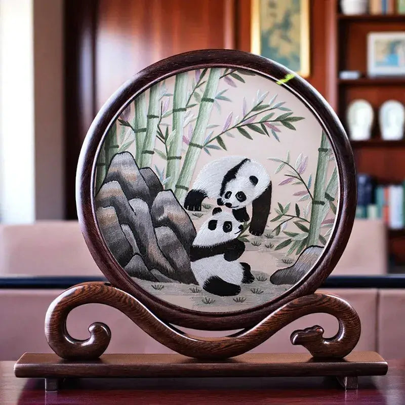 Decorative piece with a panda and bamboo design on a wooden stand