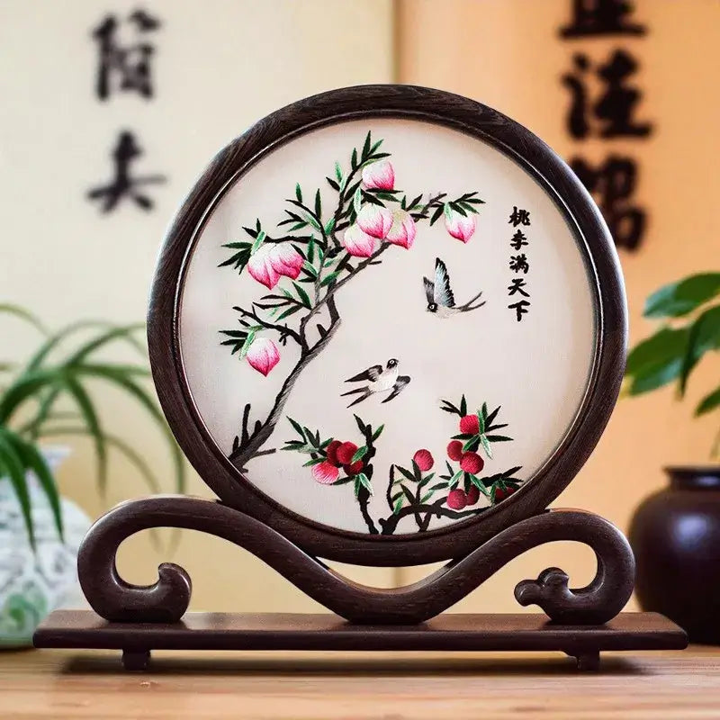 Decorative piece with floral design on a wooden stand against a blurred background