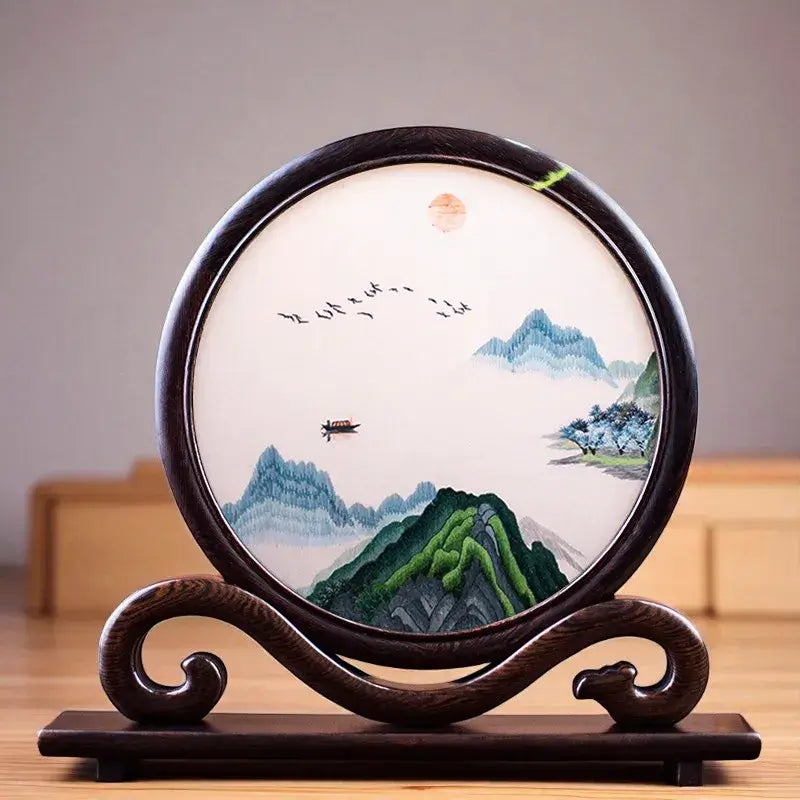Decorative piece with embroidered landscape on a wooden stand