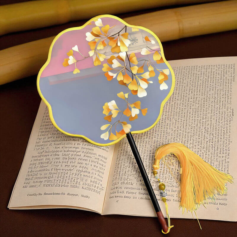 Decorative fan with floral design on an open book