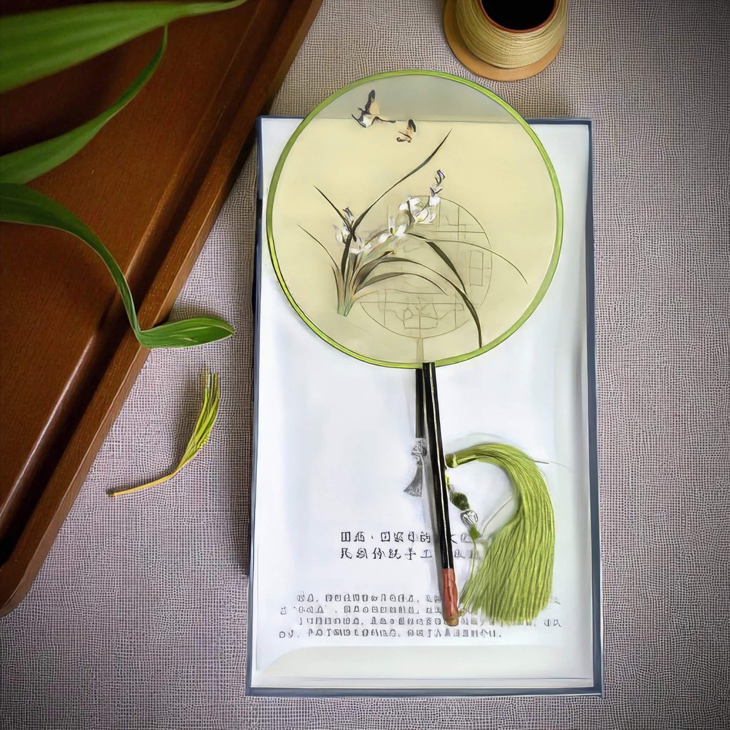 Decorative fan with floral design on a textured surface