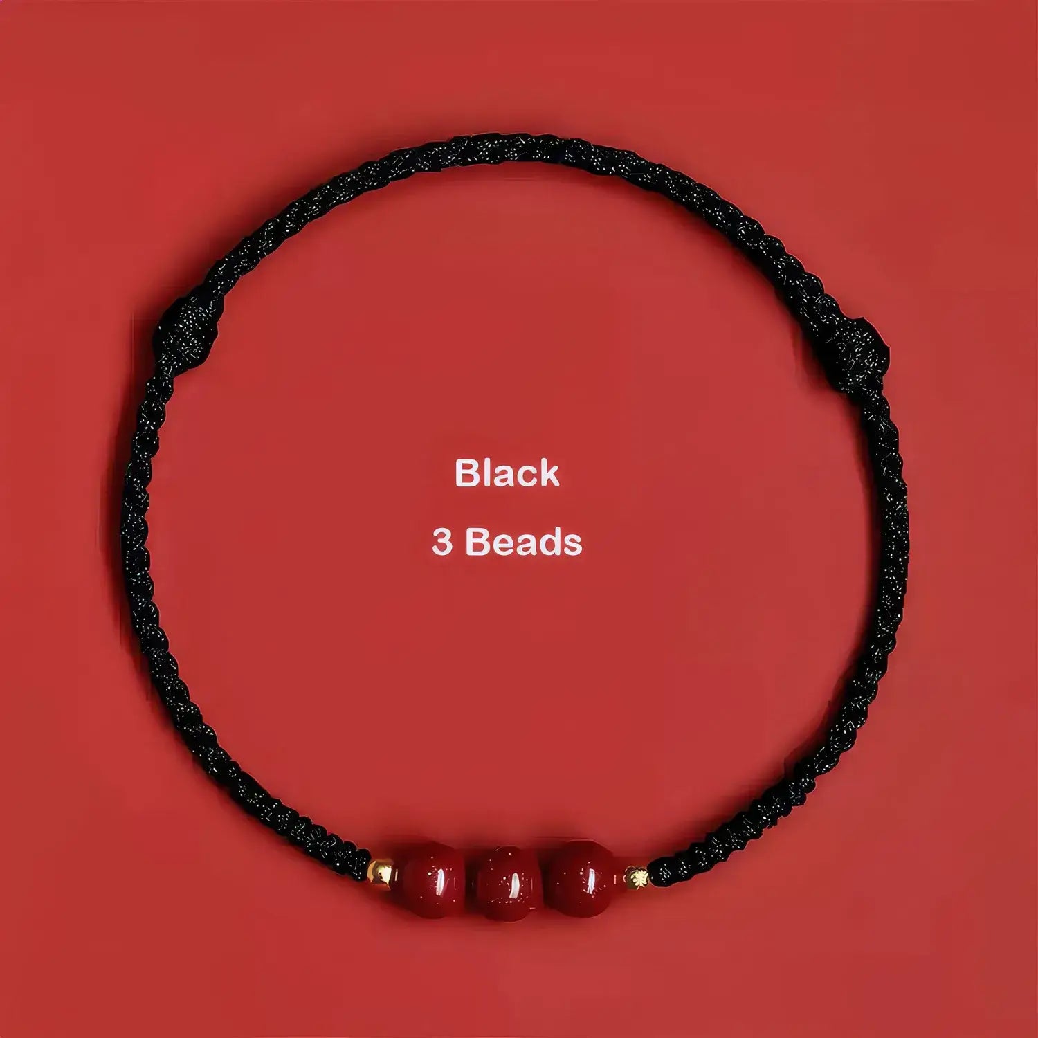Black cord with three red beads on a red background