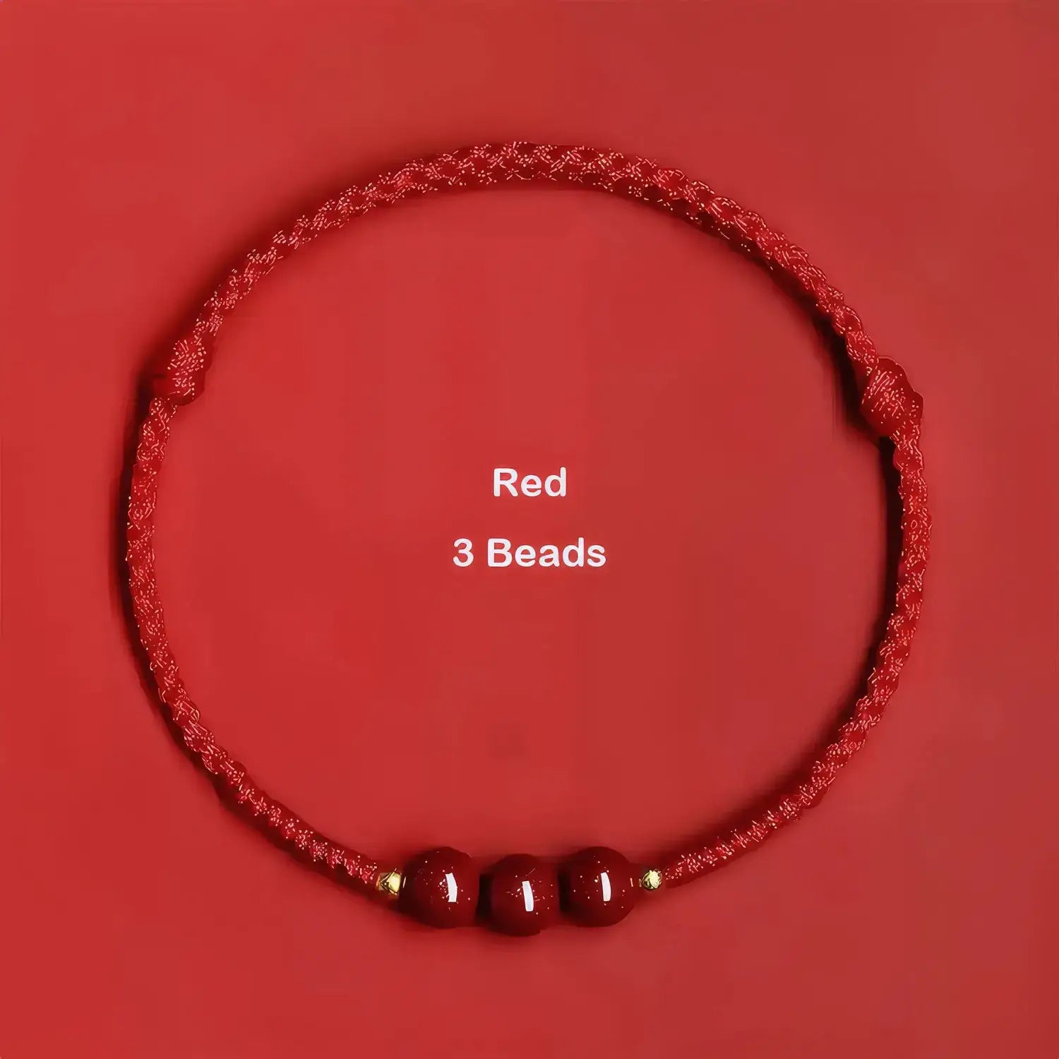 Red cord bracelet with three beads on a red background