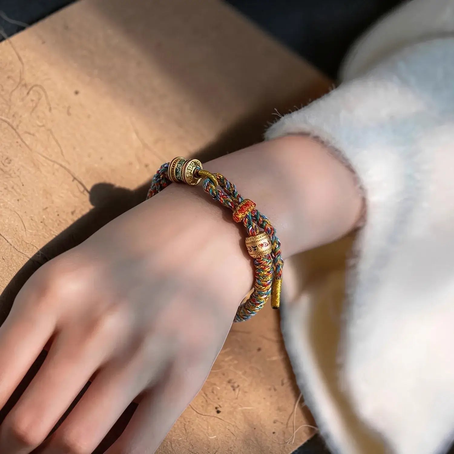 Colorful braided bracelet on a wrist with a blurred background