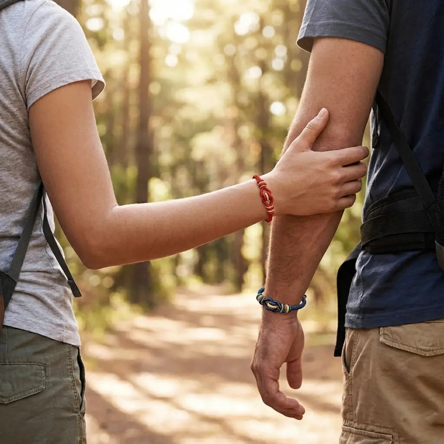 Two people holding hands in a forest setting
