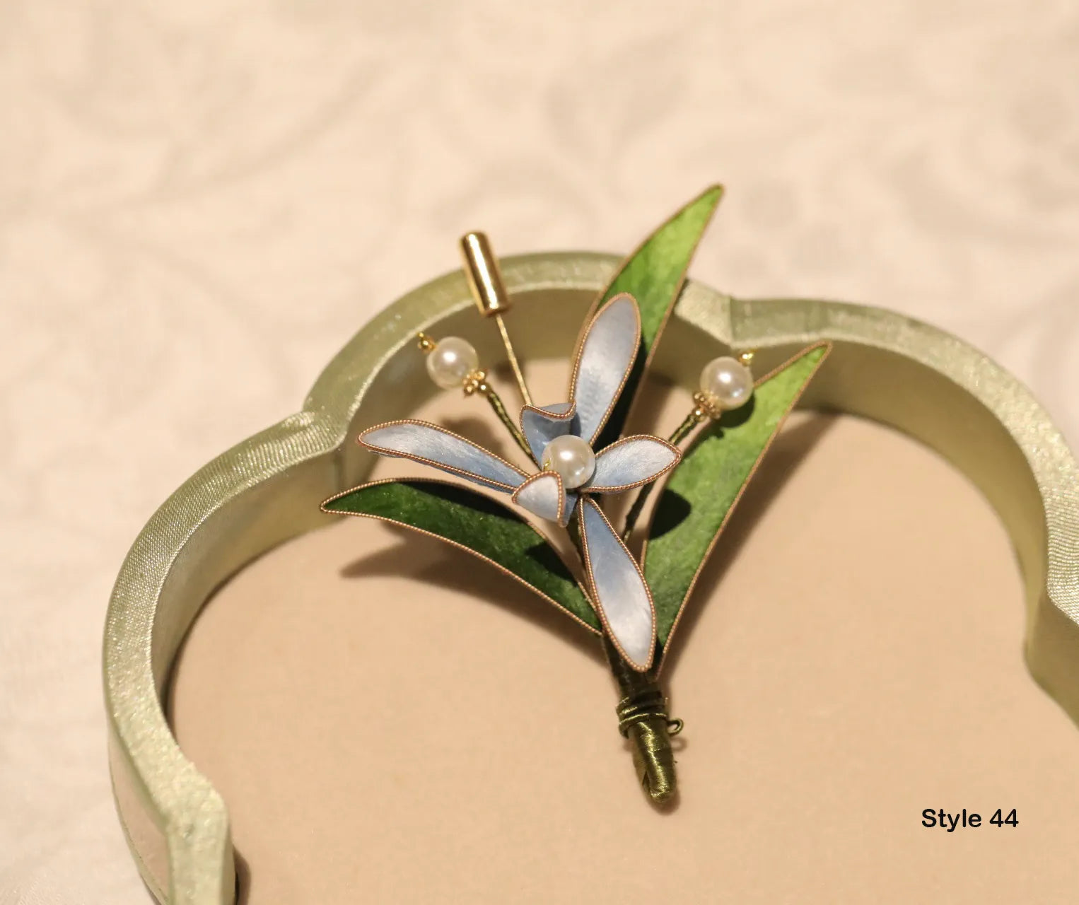 Jewelry piece with floral design on a beige background