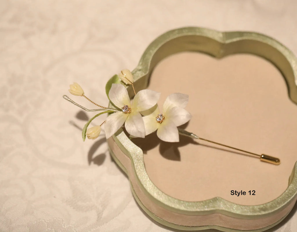 Floral hairpin with gold accents on a beige background