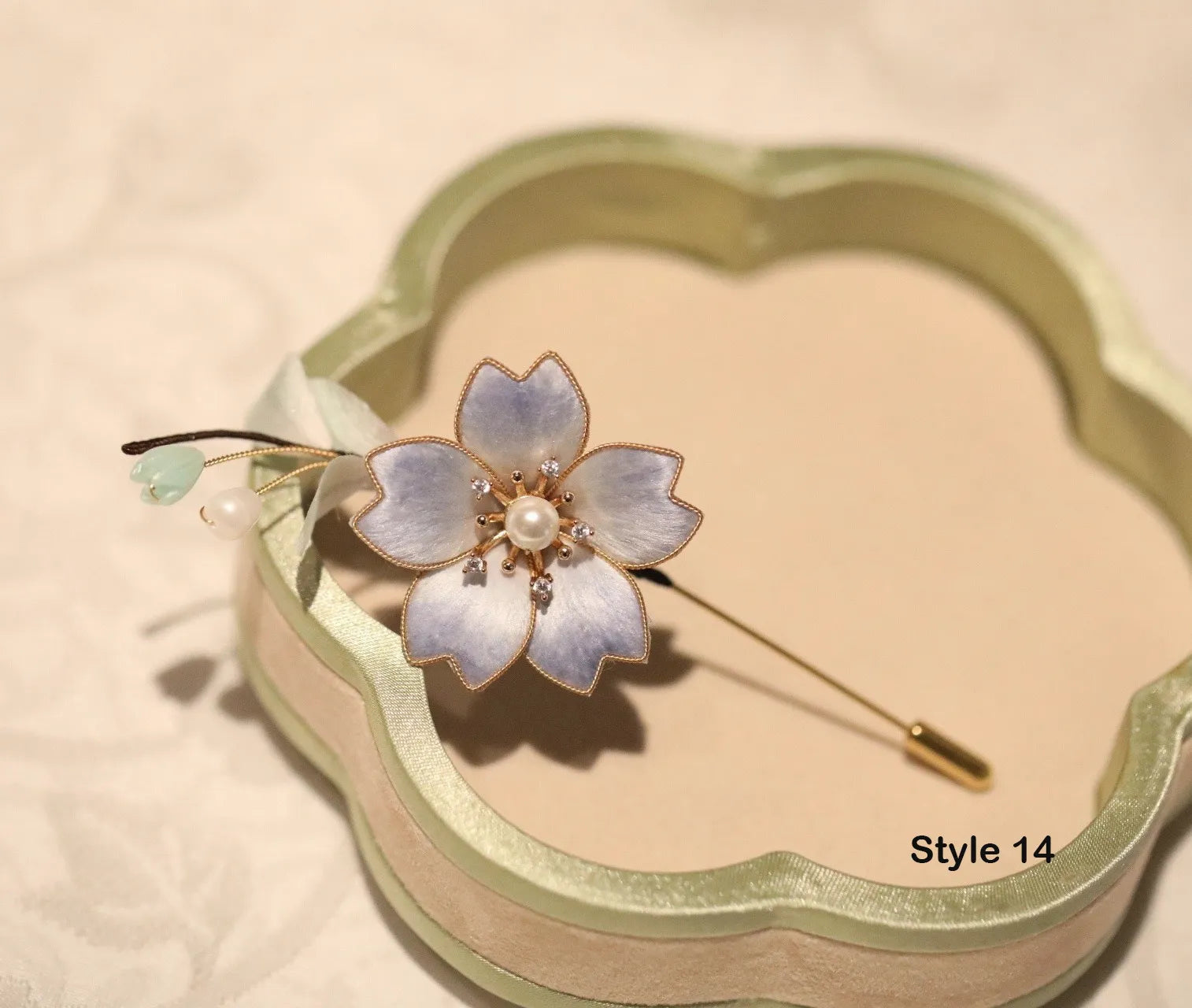 Floral brooch on a decorative box with 'Style 14' text