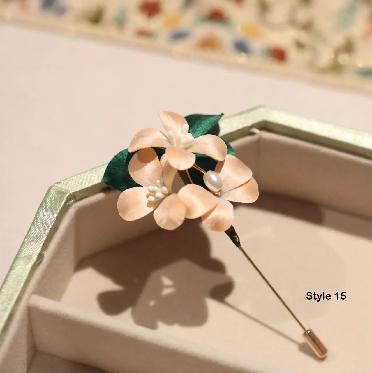 Floral brooch with a pearl on a jewelry box