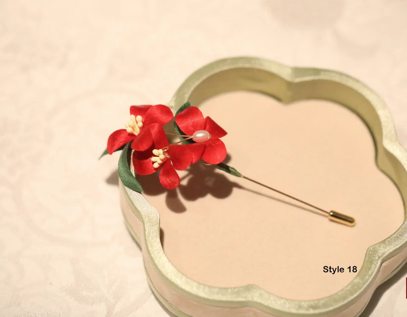 Heart-shaped hair accessory with red flowers on a beige background