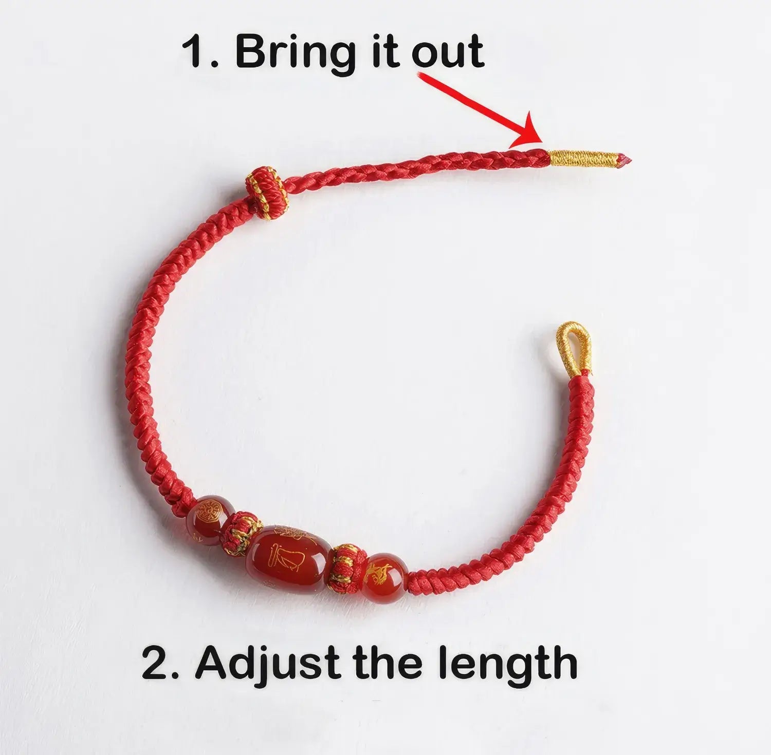 Red beaded bracelet with gold accents on a white background, showing how to adjust its length.