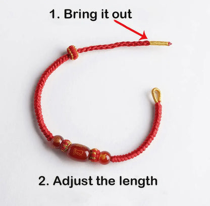 Red beaded bracelet with gold accents on a white background, showing how to adjust its length.