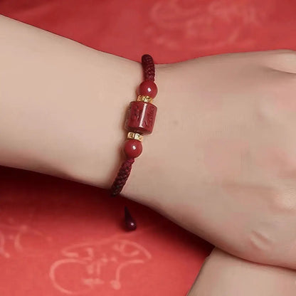 Red beaded bracelet on a wrist with a red background