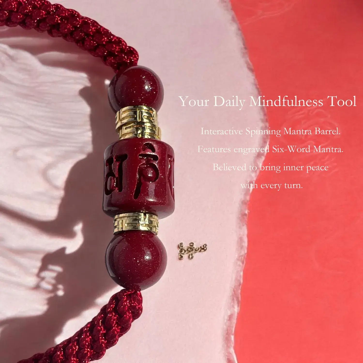 Red spining mantra barrel with gold accents on a pink background