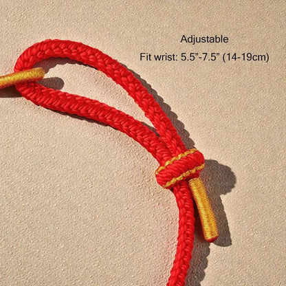 Red and gold adjustable cord on a beige background