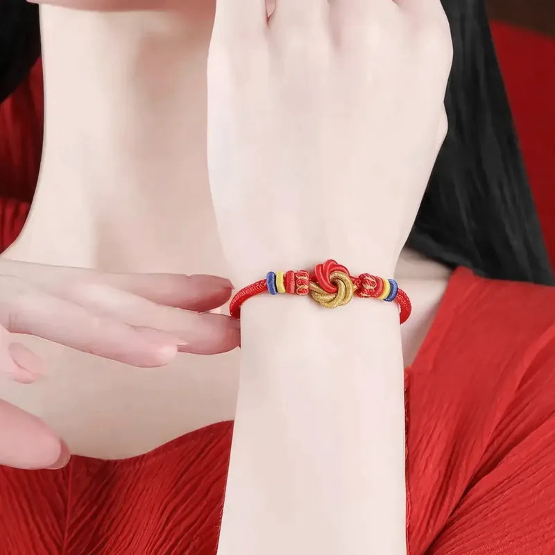 Close-up of a wrist wearing a colorful bracelet with a red background