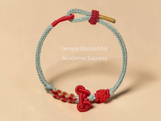 Bracelet with red and gold accents on a beige background, labeled 'Temple Blessed for Academic Success'.