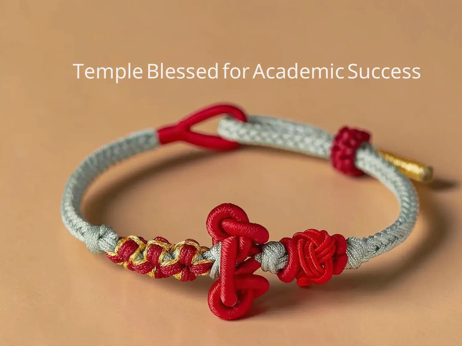 Bracelet with red and gold elements on a beige background, labeled 'Temple Blessed for Academic Success'.