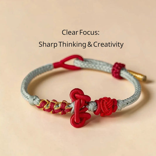 Bracelet with red and gold elements on a beige background