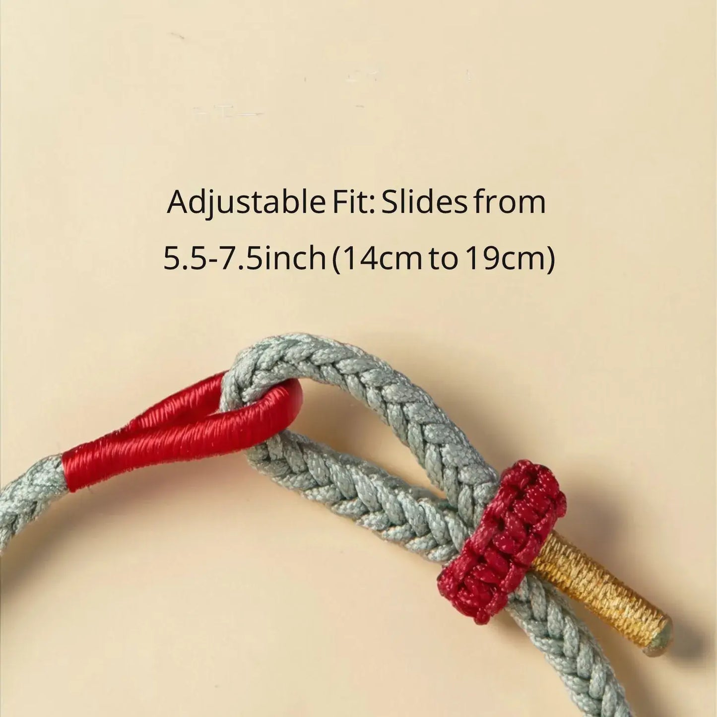 Adjustable strap with red and gold ends on a beige background