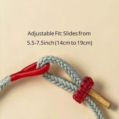 Adjustable strap with red and gold ends on a beige background