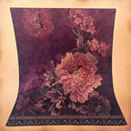 Floral patterned fabric with pink and purple flowers on a beige background