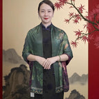 Woman wearing a traditional green and purple garment with a scenic background