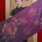 Woman holding a large piece of fabric with floral patterns in front of a red background