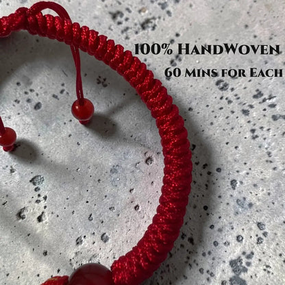 Red handwoven bracelet on a gray surface with text indicating '100% HandWoven' and '60 mins for each'.